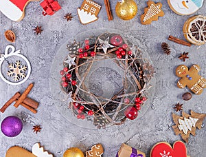 Christmas background. Christmas gift, toys, gingerbread cookies, spices and decorations on wooden background. Top view