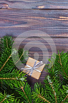 Christmas background with Christmas gift on wooden background with Fir branches. Xmas and Happy New Year composition. Flat lay, to