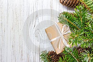 Christmas background with Christmas gift on wooden background with Fir branches. Xmas and Happy New Year composition. top view