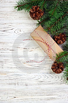 Christmas background with Christmas gift on wooden background with Fir branches. Xmas and Happy New Year composition. top view