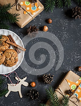 Christmas background. Christmas gifts, decorations, cookies, christmas tree. On a dark background, top view. Free space for text