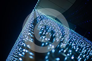 Christmas background - close up of blue and white garland lights with bokeh effect