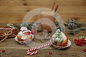 Christmas background with cocoa or hot chocolate, muffin or cupcakes with Santa Claus, snowman and Christmas tree, candy cane