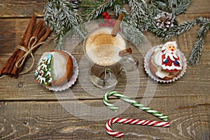 Christmas background with cocoa or hot chocolate, muffin or cupcakes with Santa Claus, snowman and Christmas tree, candy cane