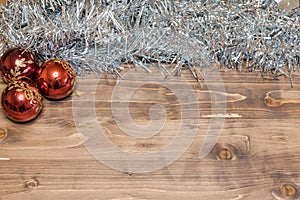 Christmas background. Colored tinsel on a wooden background