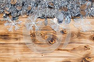 Christmas background. Colored tinsel on a wooden background