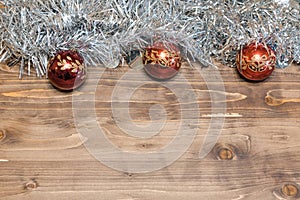 Christmas background. Colored tinsel on a wooden background