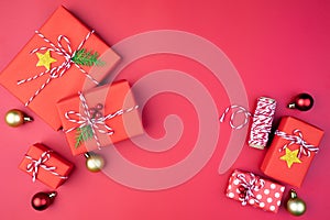 Christmas background concept. Top view of Christmas gift box red sock with spruce branches and ball on red background