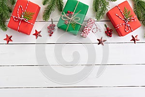 Christmas background concept. Top view of Christmas gift box with spruce branches, pine cones, red berries