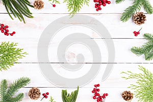 Christmas background concept. Top view of Christmas gift box with spruce branches, pine cones, red berries and bell