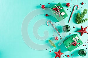 Christmas background concept. Top view of Christmas green gift box with candy cane decoration, spruce branches, star, red berries