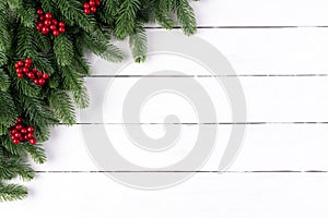 Christmas background concept. Top view of Christmas spruce branches, pine cones, red berries