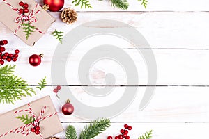 Christmas background concept. Top view of Christmas gift box with spruce branches, pine cones, red berries and bell