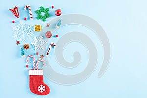 Christmas background concept. Top view of red sock splash out Christmas decoration with gift box candy cane, pine cones, red