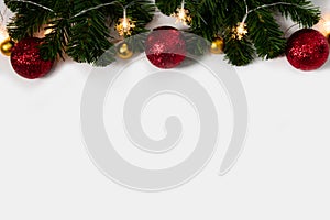 Christmas background with copy space, christmas tree with lights, red and gold ornament on white background