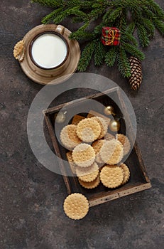 Christmas background with a cup of milk and homemade cookies for Santa Claus