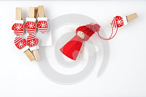 Christmas background decorated with wooden mittens on clothespins with toy angel