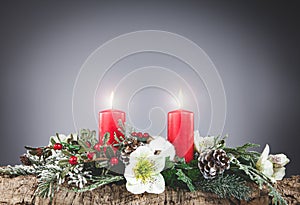 Christmas background with decorations and burning candles on a gray background