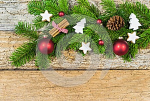 Christmas background with decorations and fir tree branch on wood