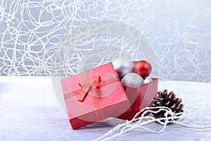 Christmas background with decorations and gift boxes on wooden board