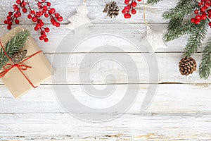 Christmas background with decorations and handmade gift boxes on white wooden board with snowflake.