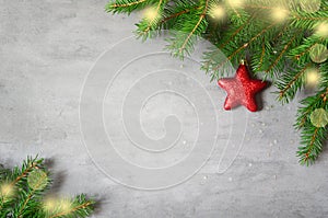 Christmas background with decorations and red stars on the gray stone background