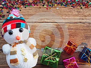Christmas background decorations with Snowman and gift boxes on the old wood board by Flat lay, top view and copy space