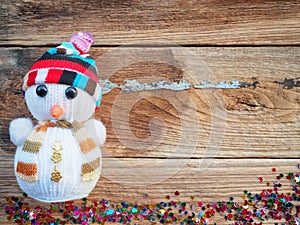 Christmas background decorations with Snowman and gift boxes on the old wood board by Flat lay, top view and copy space