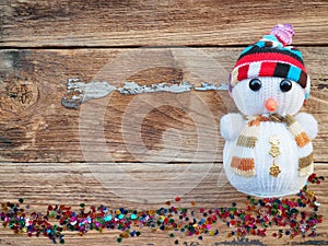 Christmas background decorations with Snowman and gift boxes on the old wood board by Flat lay, top view and copy space