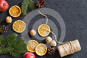 Christmas background, dried orange, cones, nuts and apples, natural decorations for christmas tree