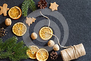 Christmas background, dried orange, cones, nuts and cookies, natural decorations for christmas tree