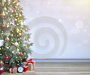 Christmas background with an elegant Christmas tree with gifts. blurred lights.