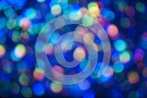 Christmas background. Festive glowing color overflows. Defocused chaotic circles Blurred bokeh photo