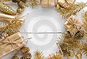 Christmas background with festive golden ornament on white wooden background. Greeting card.