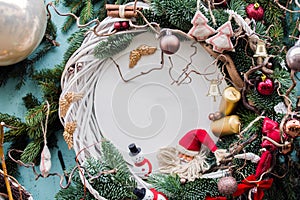 Christmas background with fir branches,baubles,candles, snowman, angel wings. Horizontal photo.