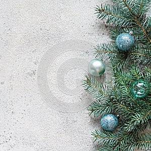 Christmas background with fir branches and decorations toys on a gray, festive mood, gift season. Winter holidays concept.