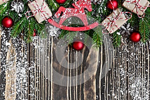 Christmas background with fir tree branches, gift boxes, decorations and pine cones