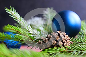 Christmas background. Fir tree and a christmas blue baubles over wooden board