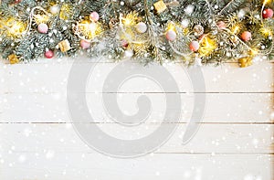 Christmas background with fir tree and decoration on white wooden board