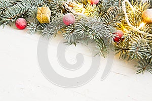 Christmas background with fir tree and decoration on white wooden board
