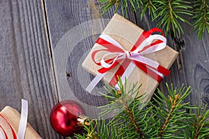Christmas background with fir tree and decorations and gift boxes on wooden board