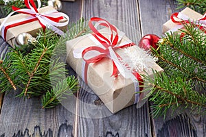 Christmas background with fir tree and decorations and gift boxes on wooden board