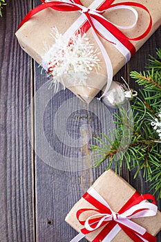 Christmas background with fir tree and decorations and gift boxes on wooden board