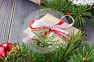 Christmas background with fir tree and decorations and gift boxes on wooden board