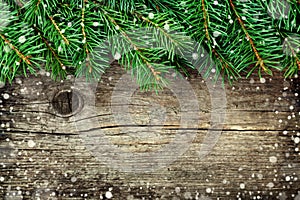 Christmas background of fir tree on old vintage wooden board, fantastic snow effect, copy space for text