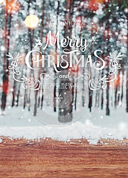 Christmas background with fir trees and blurred background of winter with text Merry Christmas and Happy New Year