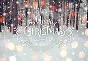 Christmas background with fir trees and blurred background of winter with text Merry Christmas and Happy New Year.