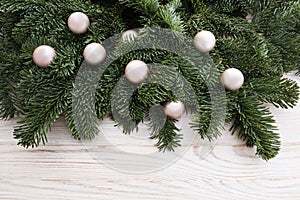 Christmas background with fir twigs and baubles on wooden table