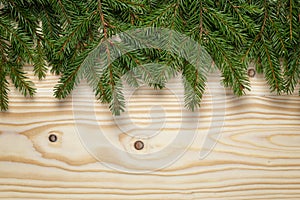 Christmas background from fir twigs on wooden table