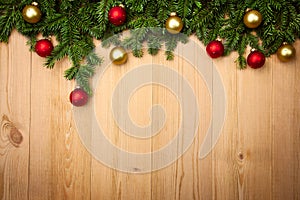 Christmas background with firtree and baubles on wood